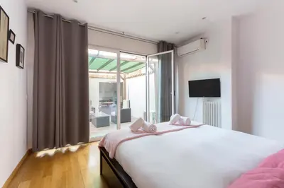a bedroom with a large bed and a large window at 1229 - AWESOME CITY CENTER APARTMENT WITH TERRACE in Barcelona