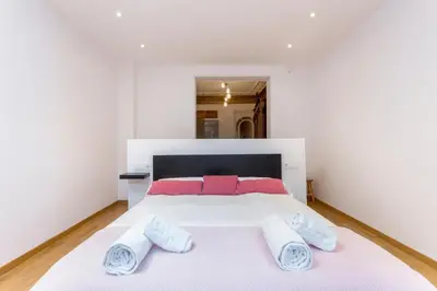 a bedroom with a large white bed with towels on it at 1229 - AWESOME CITY CENTER APARTMENT WITH TERRACE in Barcelona