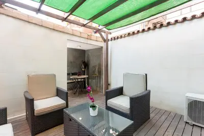 a patio with two chairs and a glass table at 1229 - AWESOME CITY CENTER APARTMENT WITH TERRACE in Barcelona