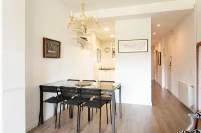 a dining room with a table and chairs at Cozy Apartment near Fira Gran Via with AC in Hospitalet de Llobregat