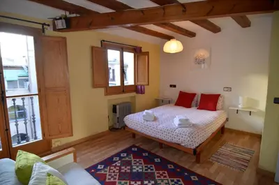 a bedroom with two beds and a living room at Central Apartment in Barcelona