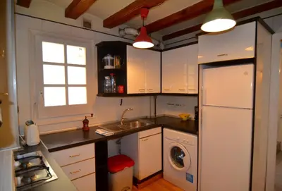 a kitchen with a white refrigerator and a sink at Central Apartment in Barcelona