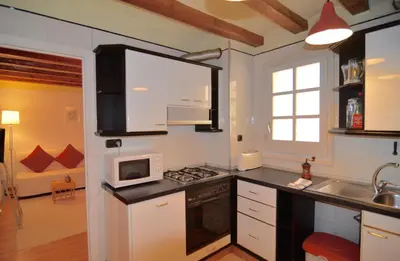 a kitchen with white cabinets and a microwave at Central Apartment in Barcelona