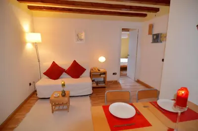 a small room with a bed and a table at Central Apartment in Barcelona