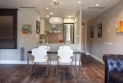 a dining room with a table and white chairs at Calabria Luxury in Barcelona