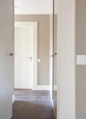 an empty room with white doors and a wooden floor at Calabria Luxury in Barcelona
