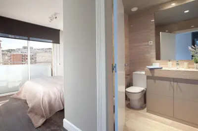 a bathroom with a bed and a sink and a toilet at Calabria Luxury in Barcelona