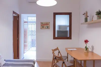 a dining room with a table and a mirror at Sweet BCN Studio with Terrace in Barcelona