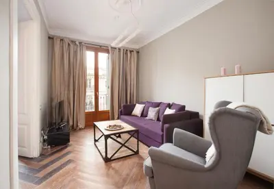 a living room with a purple couch and a table at Trafalgar Luxury in Barcelona