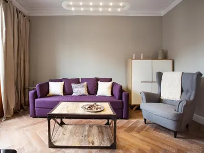 a living room with a purple couch and a chair at Trafalgar Luxury in Barcelona