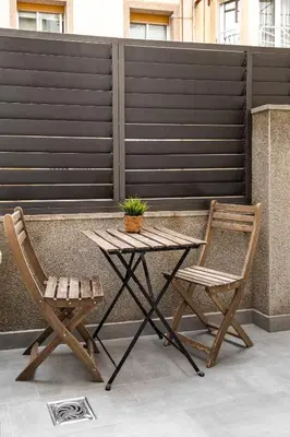 two chairs and a table on a patio at Beach Apartment, next to the sea in Premiá de Mar