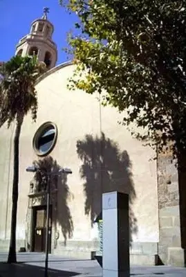 a building with a clock tower on top of it at Beach Apartment, next to the sea in Premiá de Mar