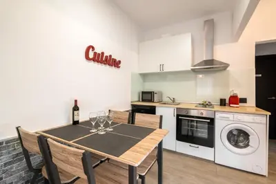a kitchen with a table with wine glasses on it at Beach Apartment, next to the sea in Premiá de Mar