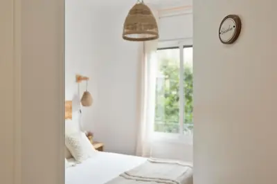 a bedroom with a bed and a clock on the wall at KeyFamily Sweet Home in Barcelona