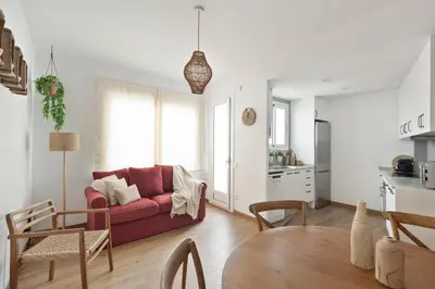 a living room with a red couch and a table at KeyFamily Sweet Home in Barcelona