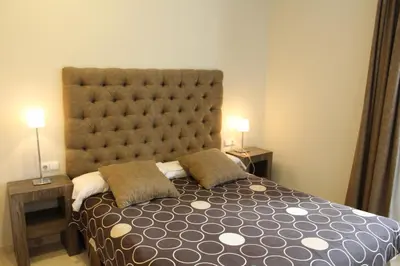 a bedroom with a large bed with a large headboard at Apartaments St. Jordi Comtal in Barcelona
