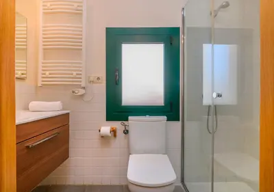 a bathroom with a toilet and a glass shower at Apartaments Rural Montseny in gualba de Dalt