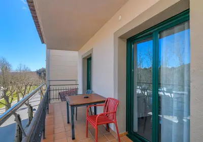 a balcony with a table and chairs on a balcony at Apartaments Rural Montseny in gualba de Dalt