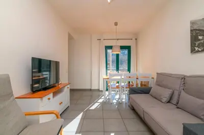 a living room with a couch and a tv at Apartaments Rural Montseny in gualba de Dalt