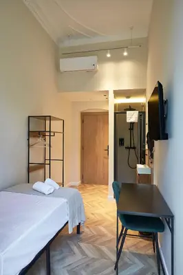 a bedroom with a bed and a chair and a desk at Ella Hostel Boqueria in Barcelona