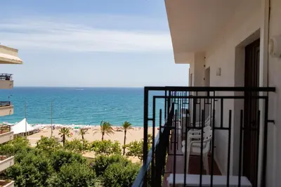 a balcony with a view of the beach at Hotel Haromar in Calella