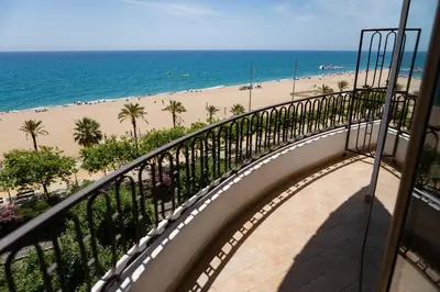 a balcony with a view of the beach at Hotel Haromar in Calella