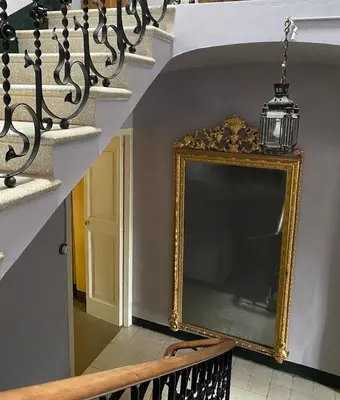 a picture frame on the wall next to a staircase at B&B Can Casadella in Premia de Dalt