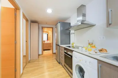 a kitchen with a washing machine and a washer at Matarolux 14 in Mataró