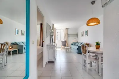 a living room with a couch and a table at Hauzify I Apartaments Sot del Morer in San Pol de Mar