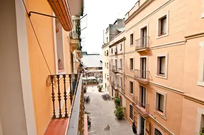 a view of an alley from a balcony of a building at Barceloneta Suites Apartments Market in Barcelona
