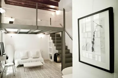 a living room with a loft bed and a couch at Barceloneta Suites Apartments Market in Barcelona