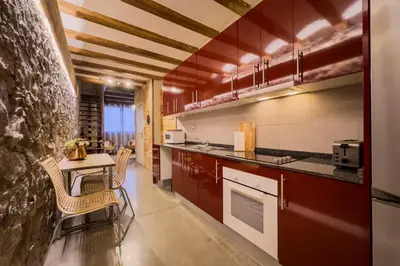 a kitchen with a table and chairs in a room at Novus Homes Barcelona Poble Sec in Barcelona