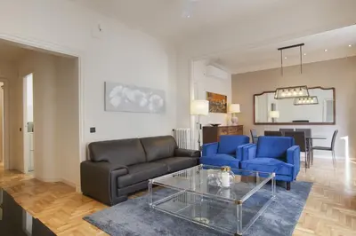 a living room with two blue couches and a glass table at Tendency Sagrada Familia Luxury in Barcelona