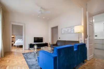 a living room with a blue couch and a table at Tendency Sagrada Familia Luxury in Barcelona
