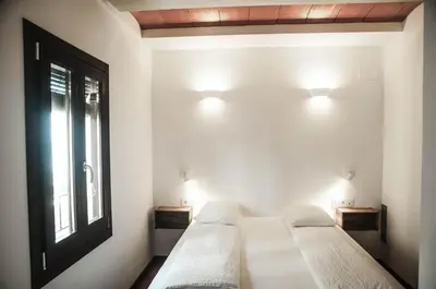 a room with two beds and a window and lights at Barcelona Beach Apartments in Barcelona