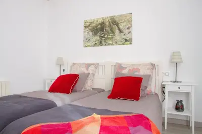 a bedroom with a bed and a plant next to a lamp at Armapana in Barcelona