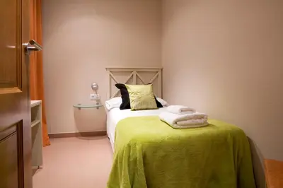a bedroom with a bed with a green blanket at BCNGOTIC 13 in Barcelona
