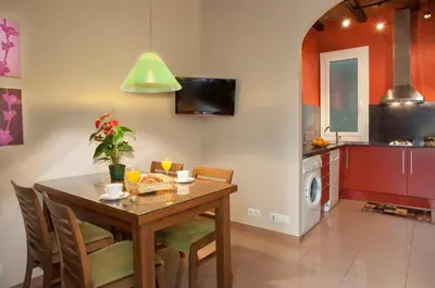 a kitchen with a table and chairs and a dining room at BCNGOTIC 13 in Barcelona