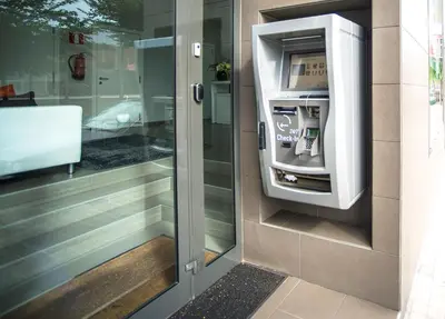 an atm machine in the corner of a building at Ona Living Barcelona in Hospitalet de Llobregat