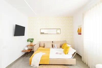 a bedroom with a bed with a yellow blanket at Ona Living Barcelona in Hospitalet de Llobregat