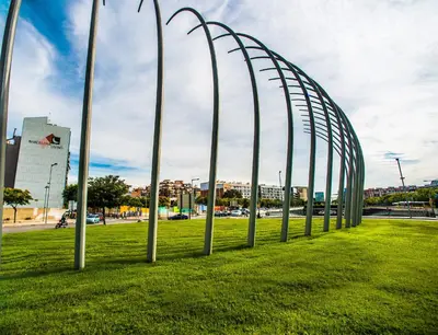 a row of metal poles in a field of grass at Ona Living Barcelona in Hospitalet de Llobregat