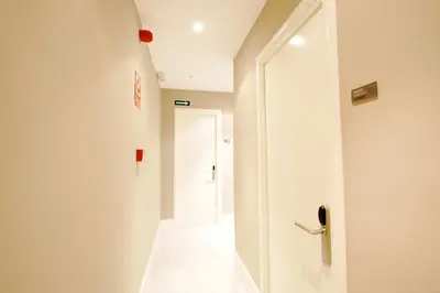 a corridor with a white door and a hallway with a door at Express by gaiarooms in Barcelona