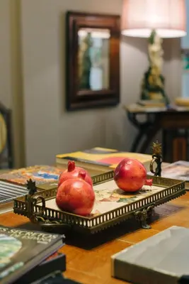 two pomegranates sitting on a tray on a table at Circa 1905 in Barcelona