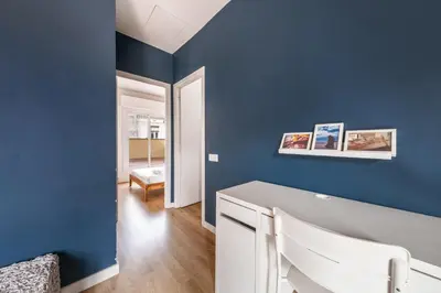 a room with blue walls and a white desk at AinB Barcelona Sants Apartments in Barcelona