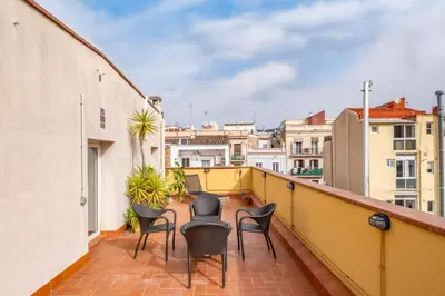 a balcony with chairs and a view of buildings at AinB Barcelona Sants Apartments in Barcelona