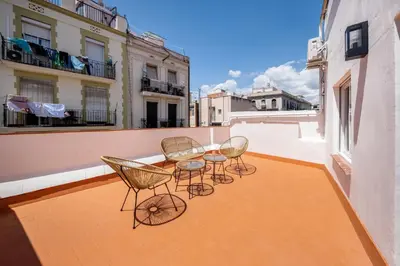 a group of chairs and tables on a balcony at AinB Barcelona Sants Apartments in Barcelona