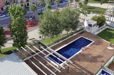 an overhead view of a swimming pool on a wooden deck at 1216 - Forum Gardens Apartment in Barcelona