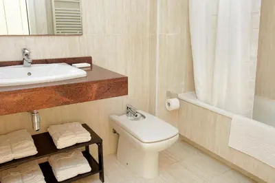 a bathroom with a toilet and a sink and a tub at 1214 - TWO BEDROOMS CIUTADELLA APARTMENT in Barcelona