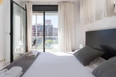 a bedroom with a large white bed and a large window at 1214 - TWO BEDROOMS CIUTADELLA APARTMENT in Barcelona