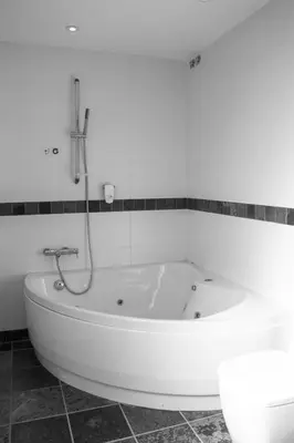 a bath tub in a bathroom with a shower at Hotel Moli De La Torre in Bigues i Riells